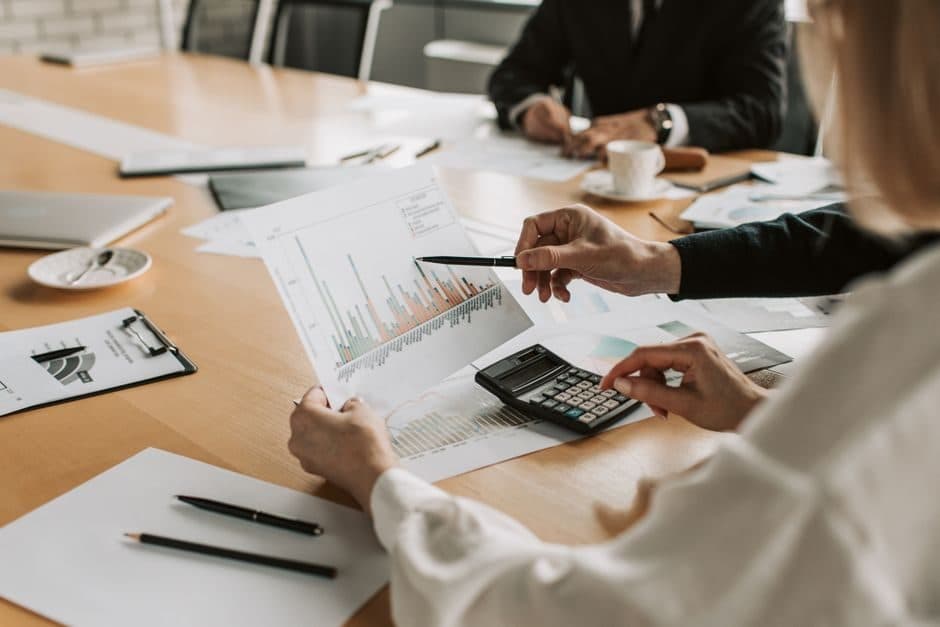 A business team reviewing performance charts in a meeting