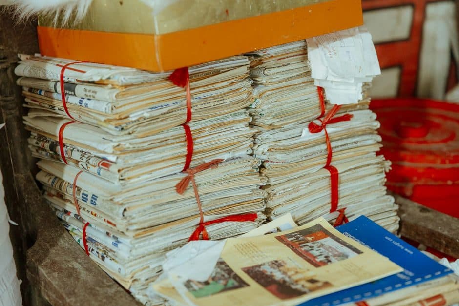 A stack of old newspapers representing the history of reputation