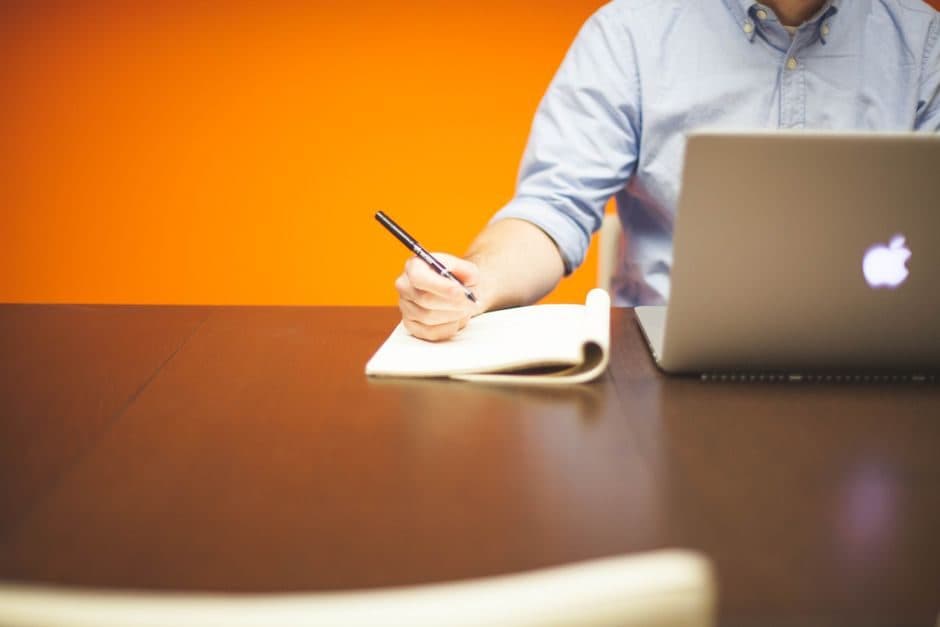 A professional working at a tidy desk with a laptop