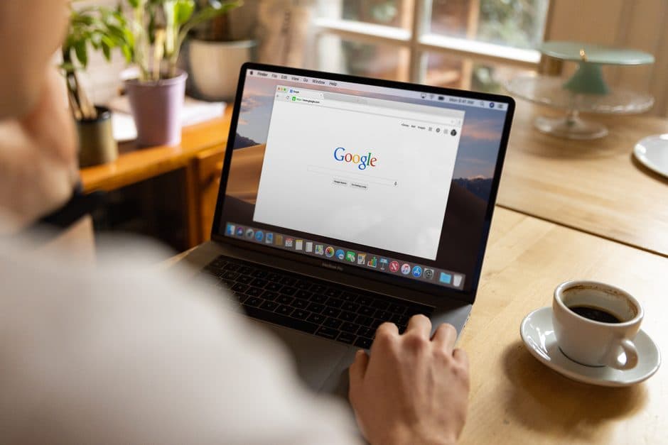 Hands typing a search query on a laptop keyboard